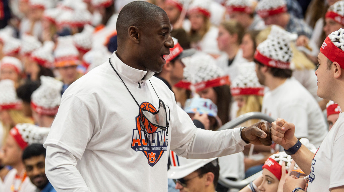 Auburn athletic director Allen Greene meets fans at a basketball game.