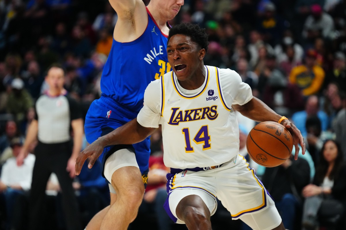 Los Angeles Lakers guard Stanley Johnson (14) drives past Denver Nuggets forward Vlatko Cancar (31) in the second half against the Denver Nuggets at Ball Arena.