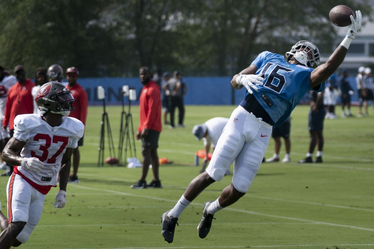 Tennessee Titans wide receiver Treylon Burks (16) makes a catch over Tampa Bay Buccaneers cornerback Kyler McMichael (37) during a joint training camp practice at Ascension Saint Thomas Sports Park.