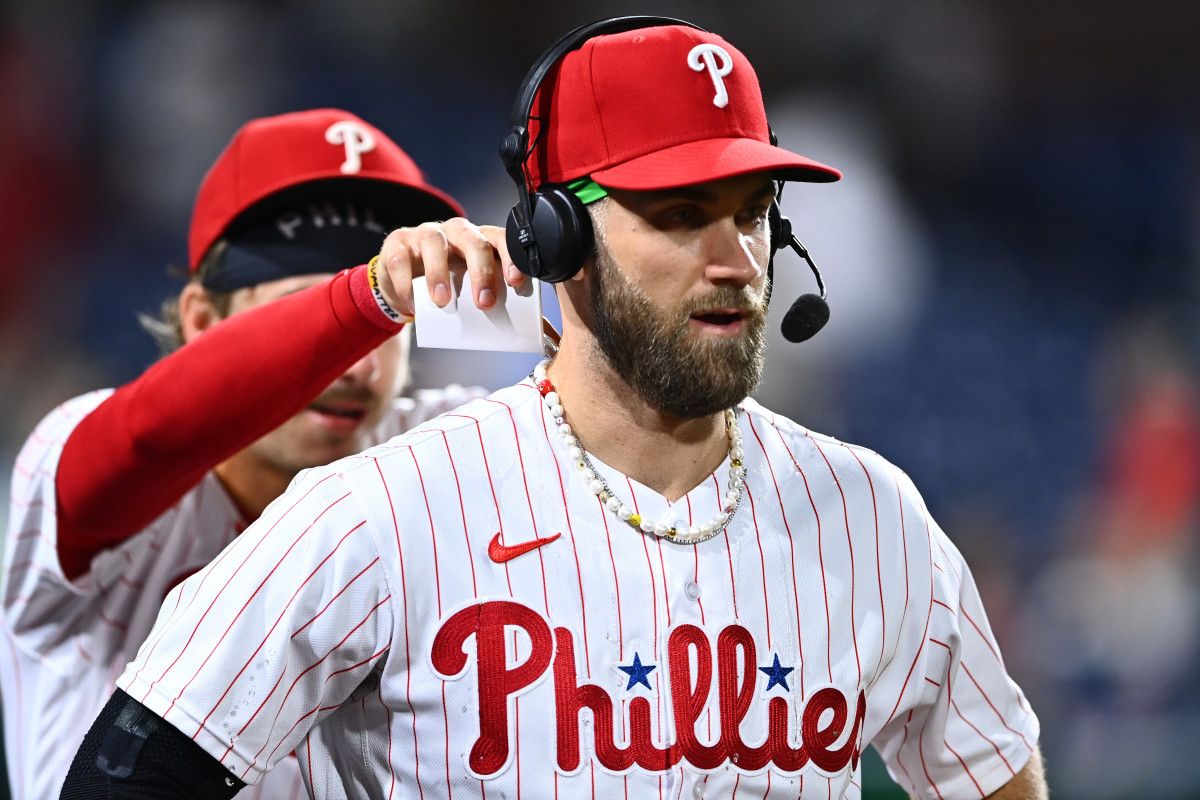Bryson Stott pours a cup of ice water down Bryce Harper's back.