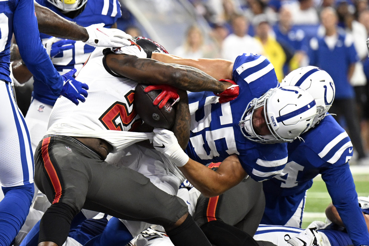 Aug 27, 2022; Indianapolis, Indiana, USA; Tampa Bay Buccaneers running back Ke'Shawn Vaughn (21) is tackled by Indianapolis Colts linebacker Sterling Weatherford (55) during the second quarter at Lucas Oil Stadium. Mandatory Credit: Marc Lebryk-USA TODAY Sports