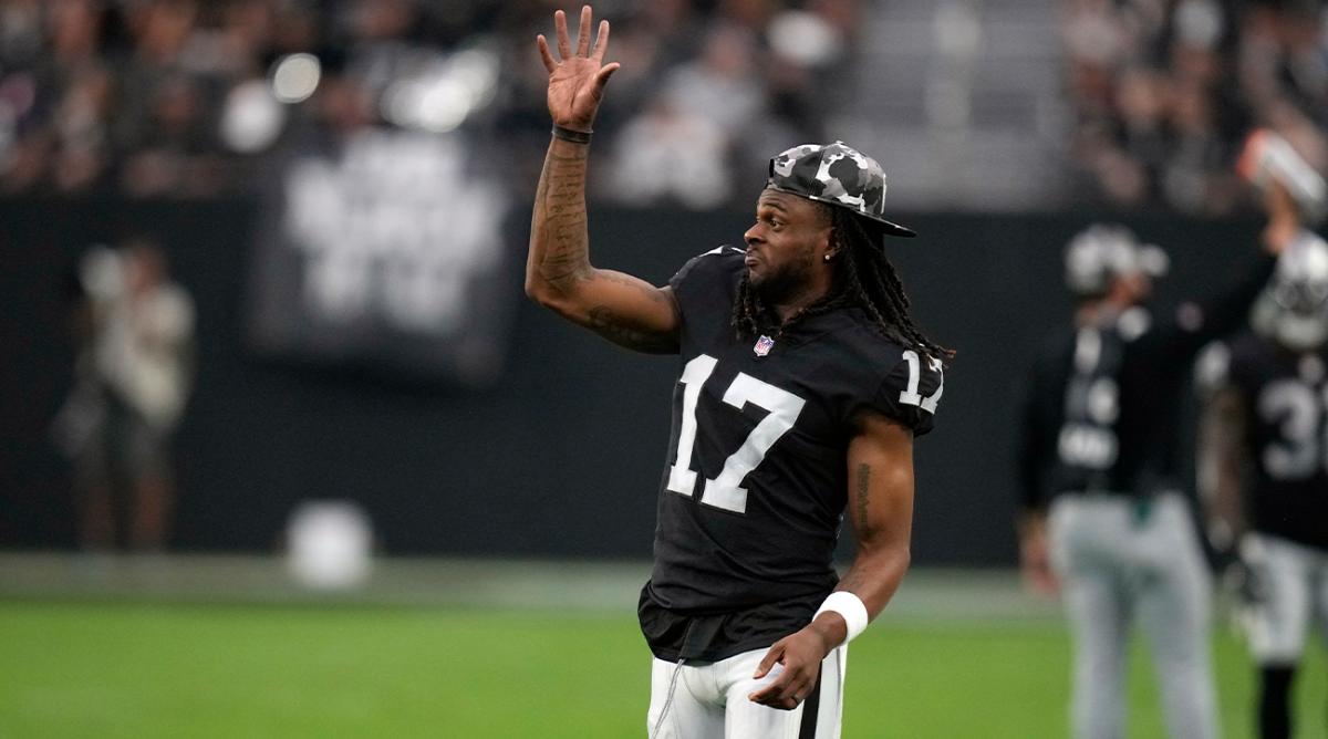 Las Vegas Raiders wide receiver Davante Adams (17) signals from the sideline during the first half of an NFL preseason football game against the New England Patriots, Friday, Aug. 26, 2022, in Las Vegas.