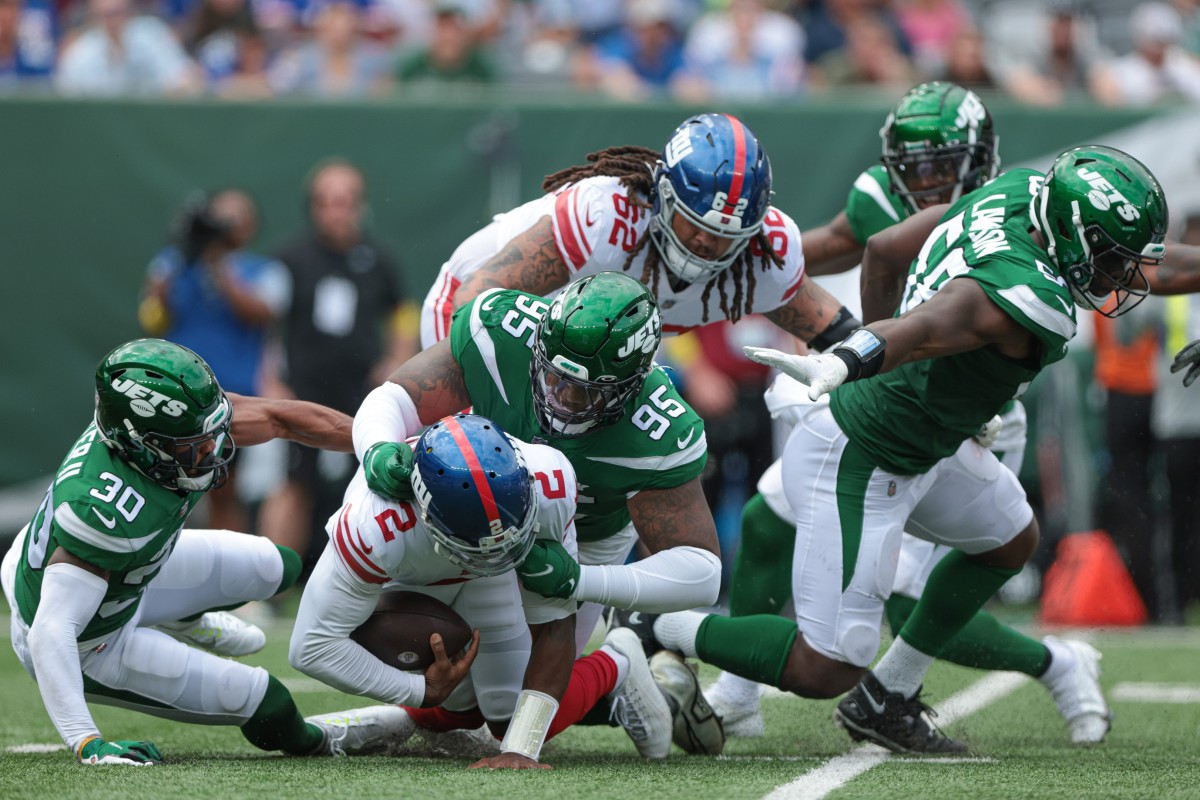 Aug 28, 2022; East Rutherford, New Jersey, USA; New York Jets defensive tackle Quinnen Williams (95) sacks New York Giants quarterback Tyrod Taylor (2) with cornerback Michael Carter II (30) during the first half at MetLife Stadium.