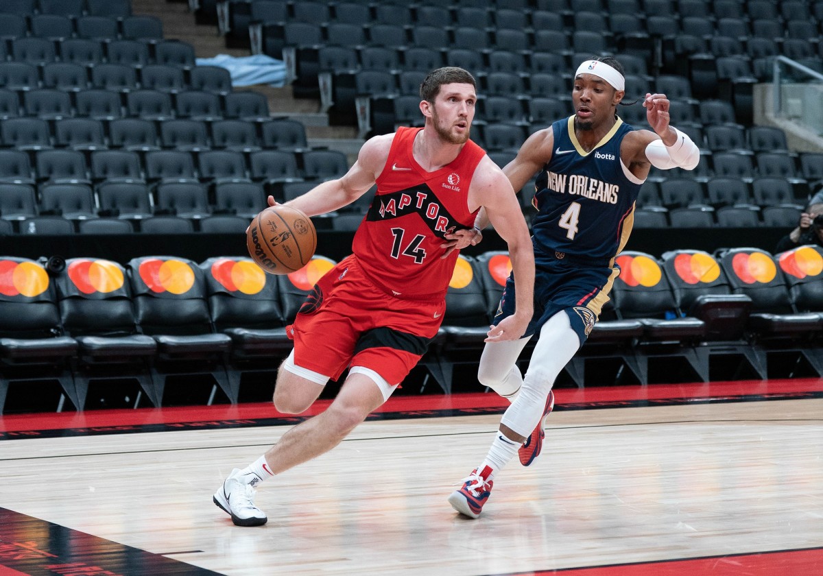Toronto Raptors guard Svi Mykhailiuk (14) drives to the basket as New Orleans Pelicans guard Devonte' Graham (4) tries to defend during the second quarter at Scotiabank Arena