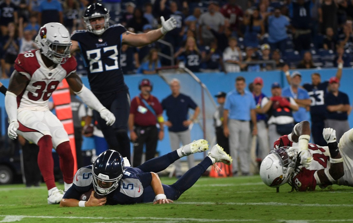 Tennessee Titans quarterback Logan Woodside (5) dives into the end zone for a touchdown past Arizona Cardinals safety Tae Daley (48) during the fourth quarter of an NFL preseason game at Nissan Stadium Saturday, Aug. 27, 2022, in Nashville, Tenn.