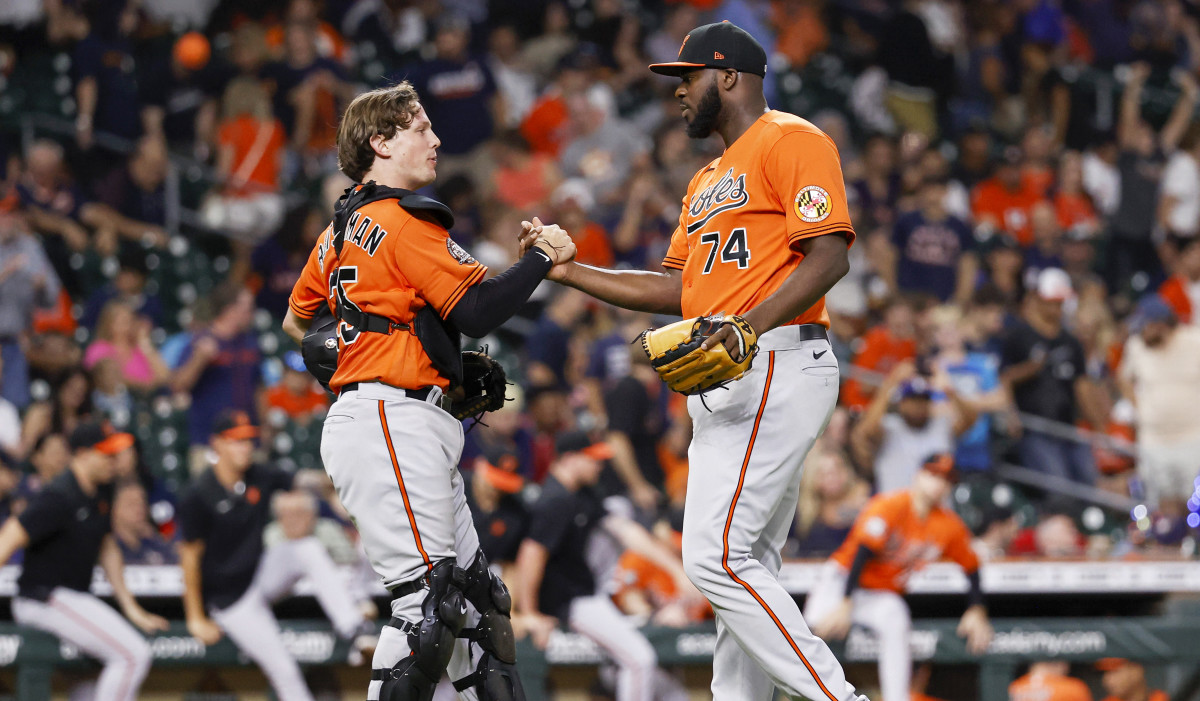 Aug 27, 2022; Houston, Texas, USA; Baltimore Orioles catcher Adley Rutschman (35) and relief pitcher Felix Bautista (74) celebrate after the Orioles defeated the Houston Astros at Minute Maid Park.