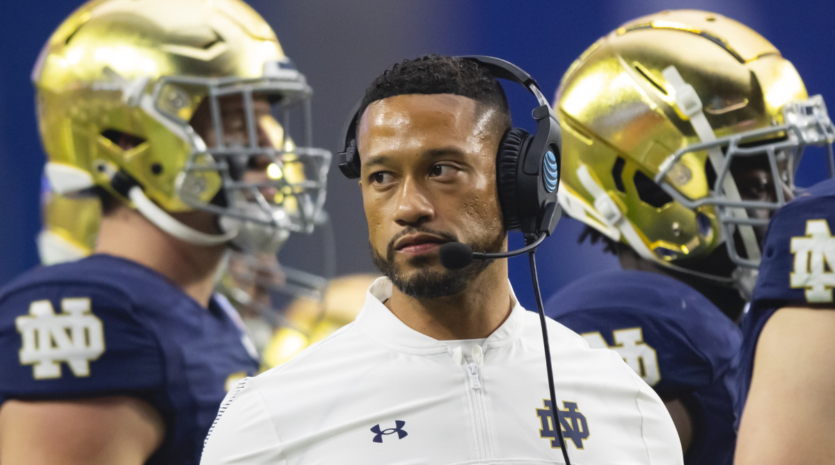 Notre Dame coach with severel players in background at 2022 Fiesta Bowl