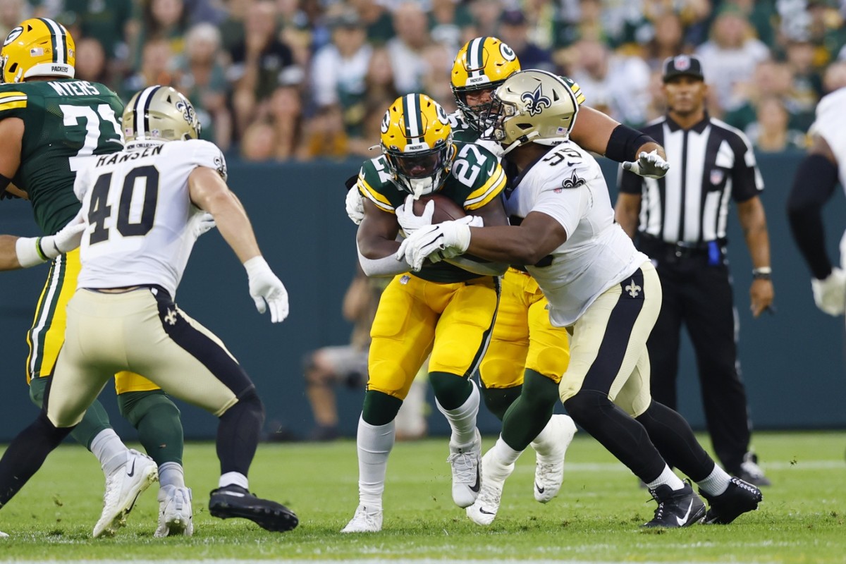 Green Bay Packers running back Patrick Taylor (27) is tackled by New Orleans Saints nose tackle Shy Tuttle (99). Mandatory Credit: Jeff Hanisch-USA TODAY Sports