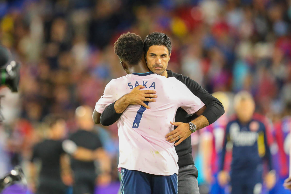 Mikel Arteta and Bukayo Saka pictured hugging after Arsenal's 2-0 win over Crystal Palace in August 2022