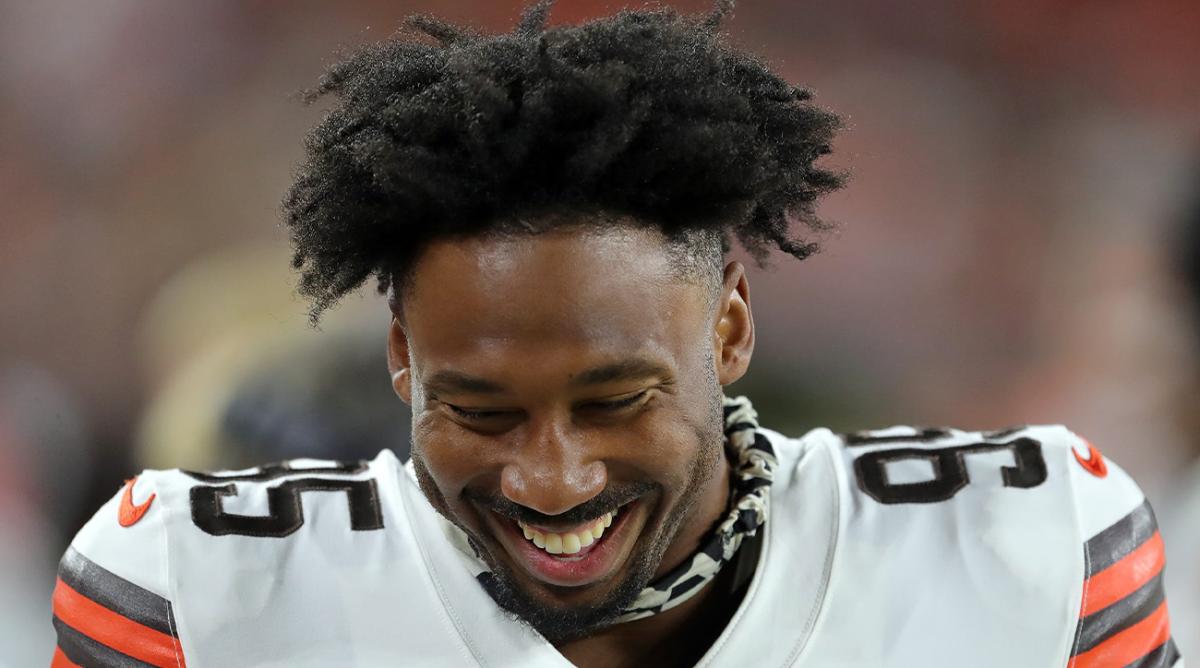 Cleveland Browns defensive end Myles Garrett (95) laughs on the sideline during the second half of an NFL preseason football game against the Cleveland Browns, Saturday, Aug. 27, 2022, in Cleveland, Ohio.