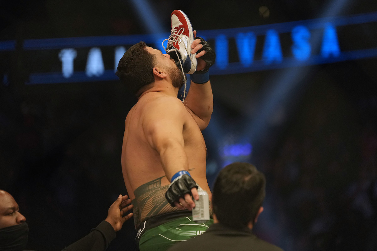 Tai Tuivasa drinks out of his shoe in celebration of his knockout victory against Agusto Sakai during UFC 269 at T-Mobile Arena.