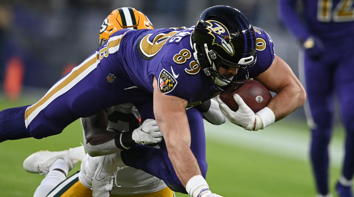 Dec 19, 2021; Baltimore, Maryland, USA; Baltimore Ravens tight end Mark Andrews (89) dives forward as Green Bay Packers defensive back Chandon Sullivan (39) defends during the first quarter at M&T Bank Stadium.