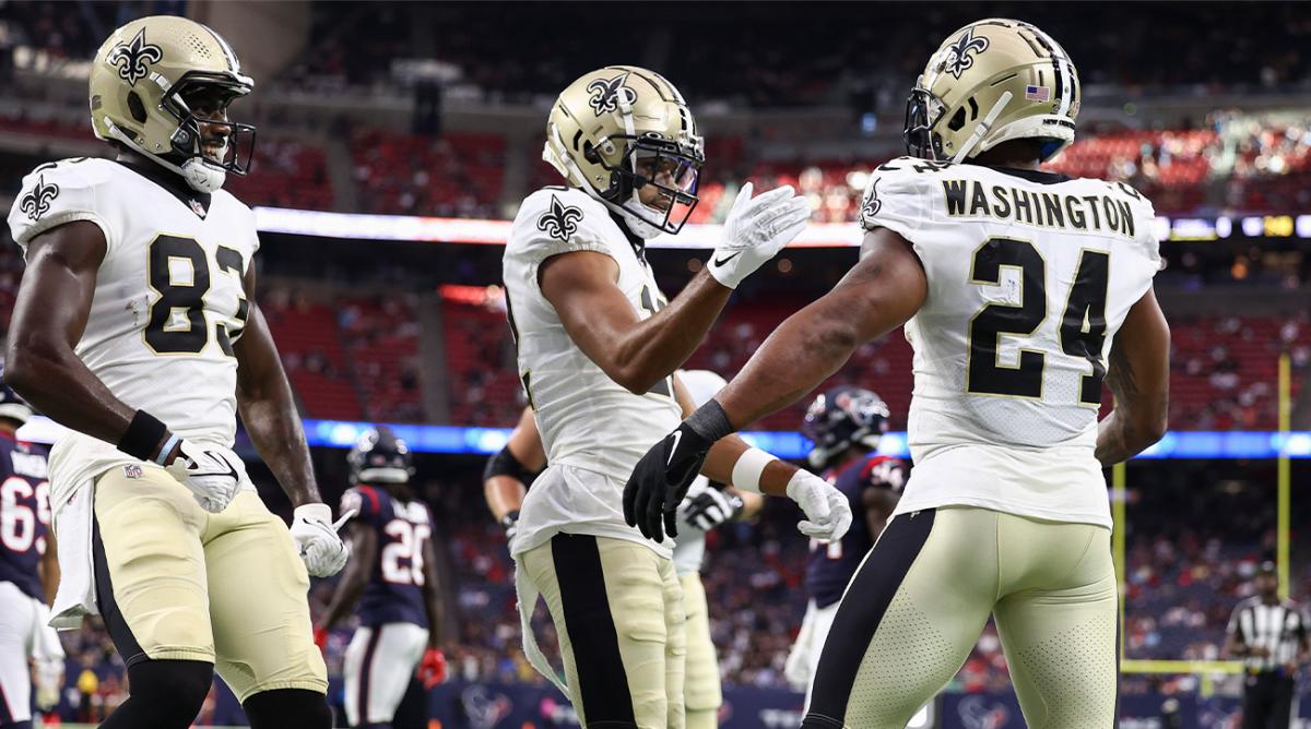 Aug 13, 2022; Houston, Texas, USA; New Orleans Saints running back Dwayne Washington (24) celebrates with wide receiver Chris Olave (12) after scoring a touchdown during the first quarter against the Houston Texans at NRG Stadium.