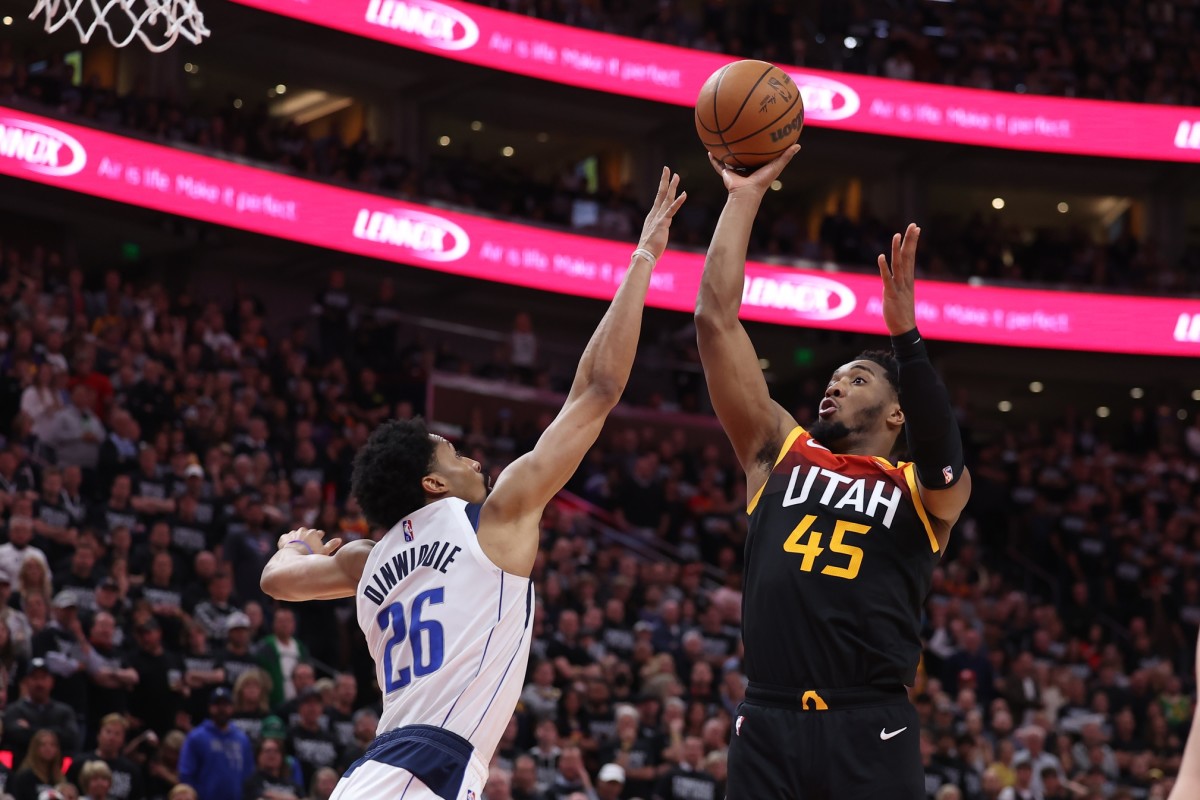 Utah Jazz guard Donovan Mitchell (45) shoots the ball over Dallas Mavericks guard Spencer Dinwiddie (26) in the fourth quarter during game six of the first round for the 2022 NBA playoffs at Vivint Arena