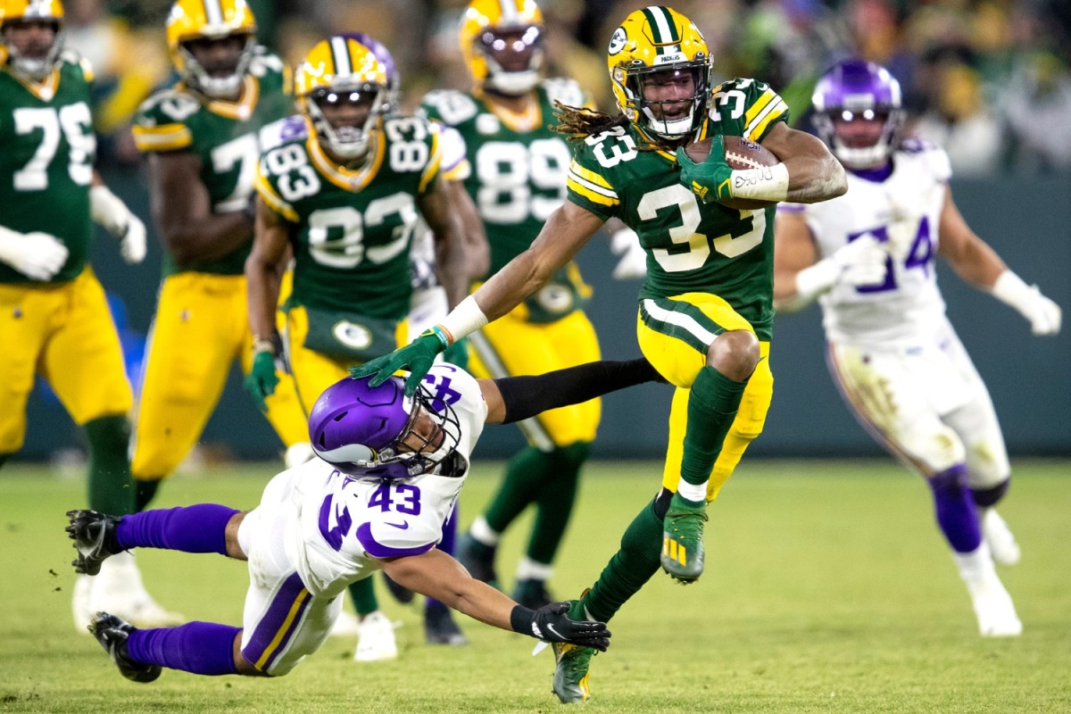 Green Bay Packers running back Aaron Jones (33) stiff arms Minnesota Vikings safety Camryn Bynum (43). Samantha Madar/USA TODAY NETWORK-Wisconsin / USA TODAY NETWORK