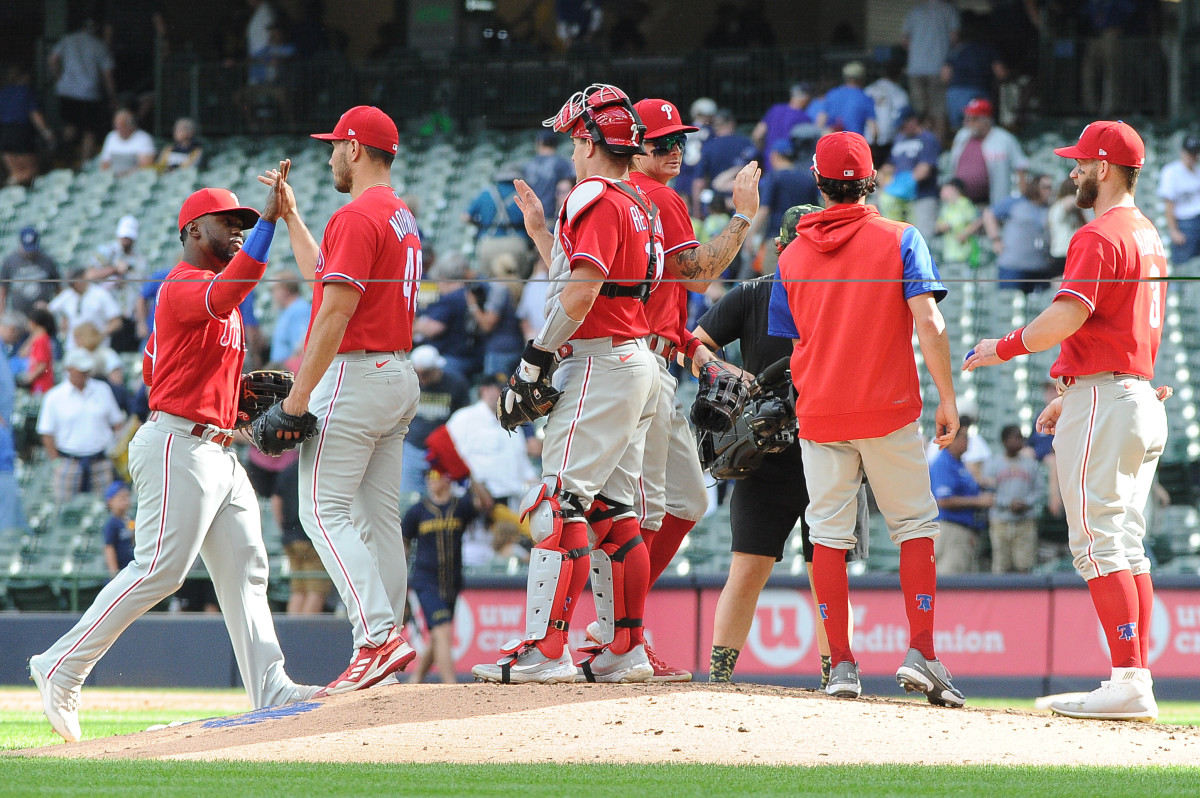 The Phillies celebrate a series sweep of the Brewers on June 9.