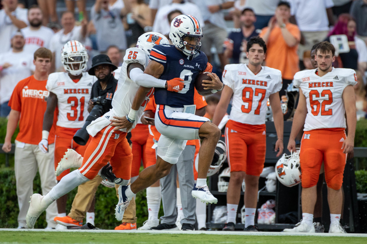 Auburn Tigers quarterback Robby Ashford (9) runs 49 yards around left corner before being dragged down from behind by Mercer Bears cornerback TJ Moore (25) during the game between the Mercer Bears and the Auburn Tigers at Jordan-Hare Stadium on Sept. 3, 2022.