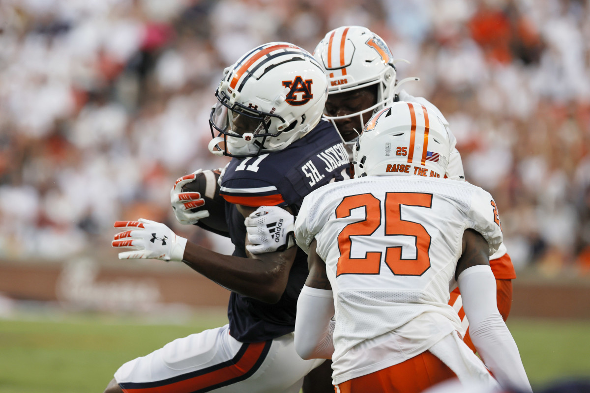 Sep 3, 2022; Auburn, Alabama, USA; Auburn Tigers wide receiver Shedrick Jackson (11) is tackled by Mercer Bears cornerback TJ Moore (25) and safety Lance Wise (0) during the first quarter at Jordan-Hare Stadium. Mandatory Credit: John Reed-USA TODAY Sports