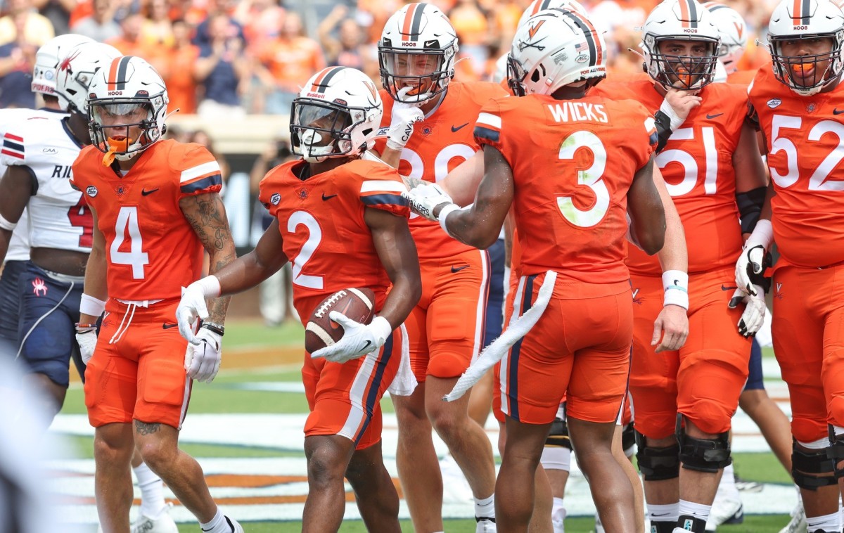 Virginia running back Perris Jones celebrates with his teammates after scoring a touchdown during UVA's 34-17 victory over Richmond on Saturday at Scott Stadium.