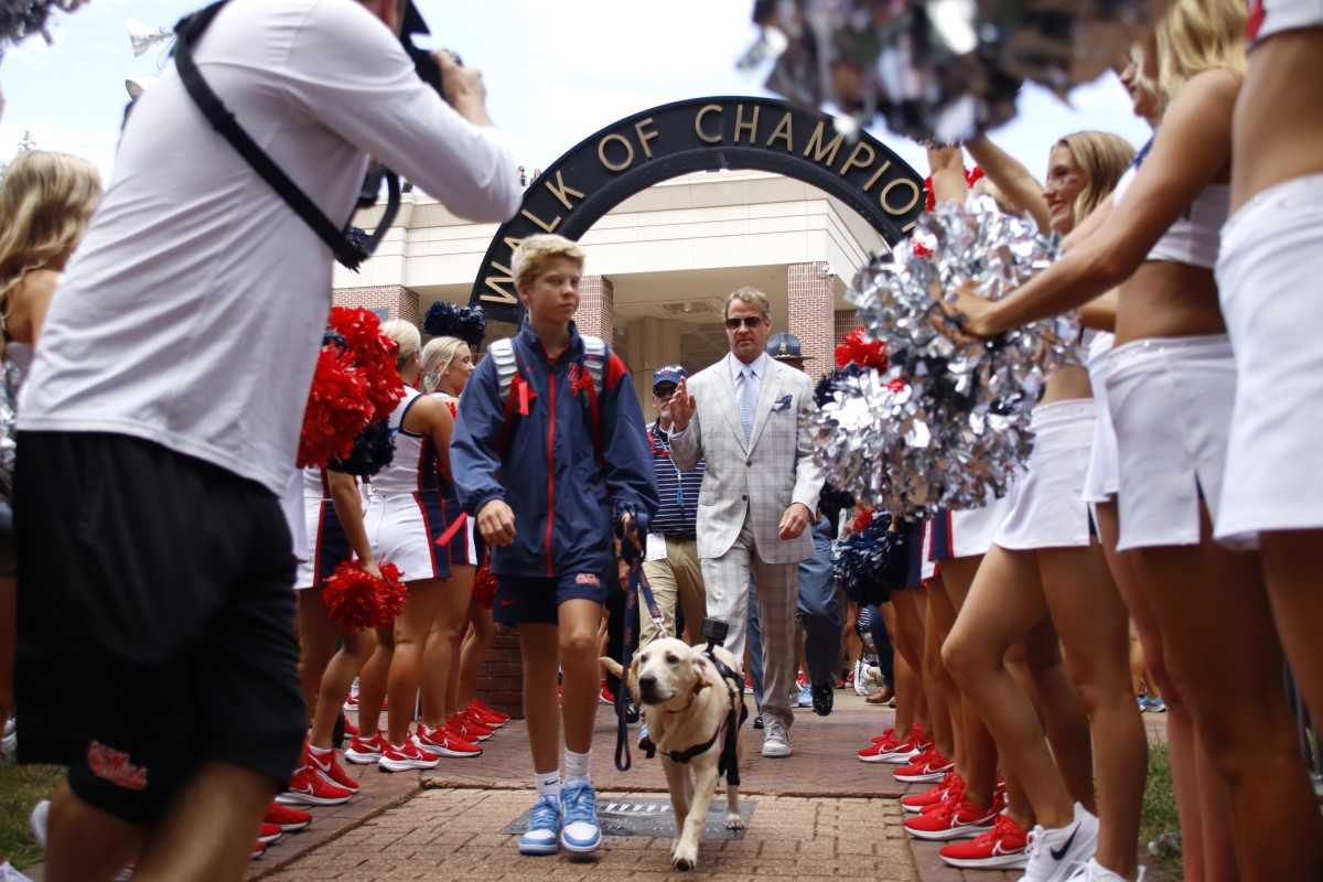 Ole Miss Rebels' Lane Kiffin and Juice walk down the Walk of Champions during the 2022 regular season.