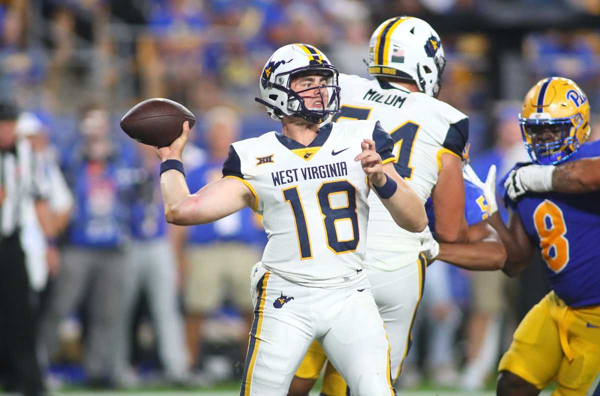 JT Daniels (18) of the West Virginia Mountaineers throws downfield while being pressured by the Panthers Defensive Line during the second half of the Backyard Brawl at Acrisure Stadium in Pittsburgh, PA on September 1, 2022.