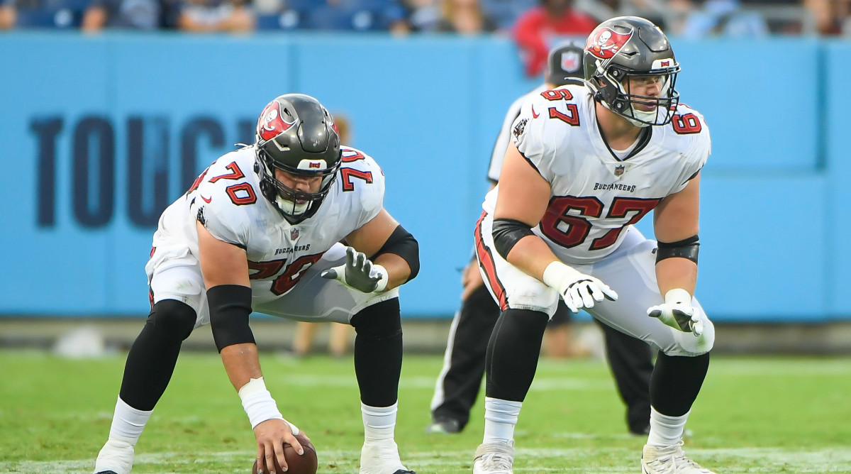 Tampa Bay Buccaneers offensive tackle Robert Hainsey (70) and guard Luke Goedeke (67) against the Tennessee Titans during the first half at Nissan Stadium.