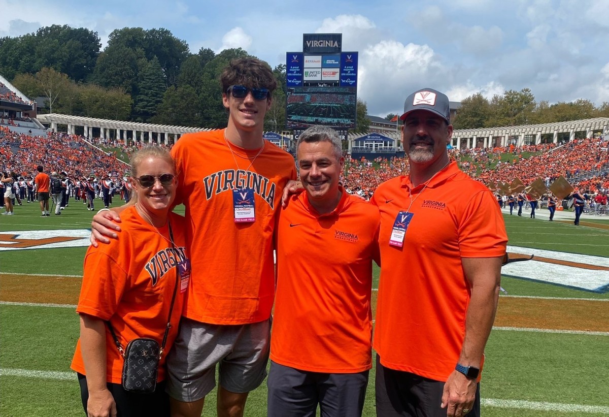 Virginia basketball commit Blake Buchanan and his family pose with UVA head coach Tony Bennett at a Virginia football game during Buchanan's official visit to UVA.