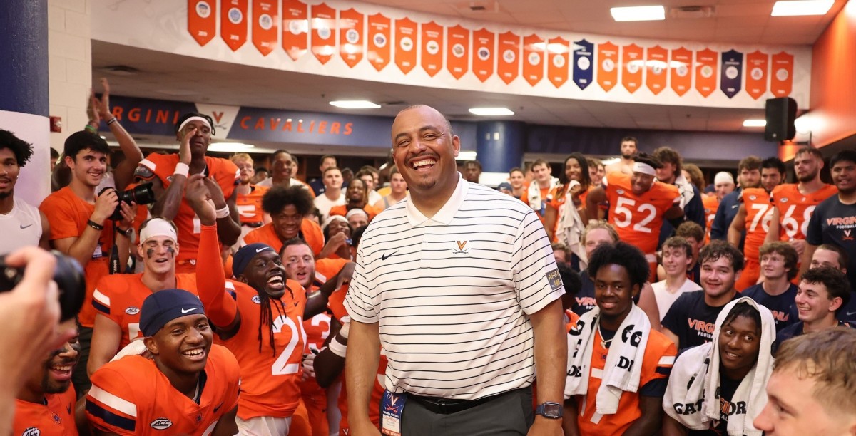 Virginia head coach Tony Elliott celebrates with his team after their victory over Richmond.
