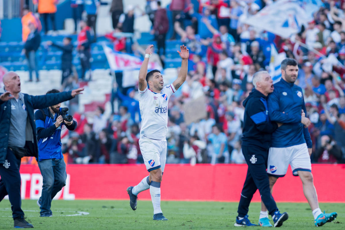 Luis Suarez pictured (center) celebrating after helping Nacional beat Penarol 3-1 in the Uruguayan Clasico in September 2022