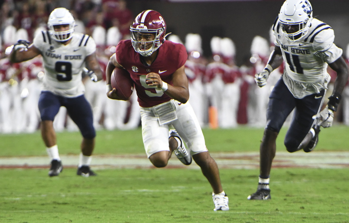 Sep 3, 2022; Tuscaloosa, Alabama, USA; Alabama Crimson Tide quarterback Bryce Young (9) outruns Utah State defensive lineman Daniel Grzesiak (9) and Utah State defensive lineman Byron Vaughns (11) at Bryant-Denny Stadium. Mandatory Credit: Gary Cosby Jr.-USA TODAY Sports