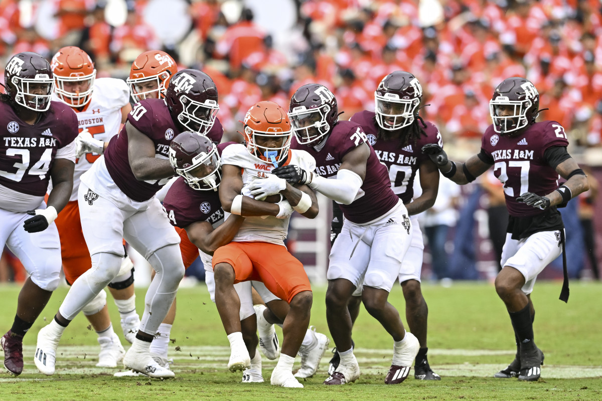 Sep 3, 2022; College Station, Texas, USA; Sam Houston State Bearkats wide receiver Noah Smith (6) is wrapped up by Texas A&M Aggies linebacker Chris Russell Jr. (24) during the third quarter at Kyle Field. Mandatory Credit: Maria Lysaker-USA TODAY Sports
