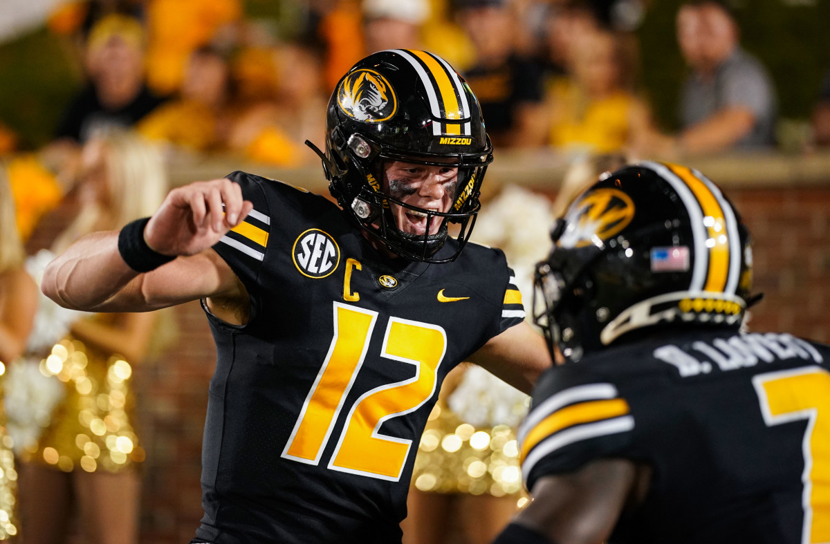 Sep 1, 2022; Columbia, Missouri, USA; Missouri Tigers quarterback Brady Cook (12) celebrates with wide receiver Dominic Lovett (7) after running for a touchdown against the Louisiana Tech Bulldogs during the second half at Faurot Field at Memorial Stadium. Mandatory Credit: Jay Biggerstaff-USA TODAY Sports