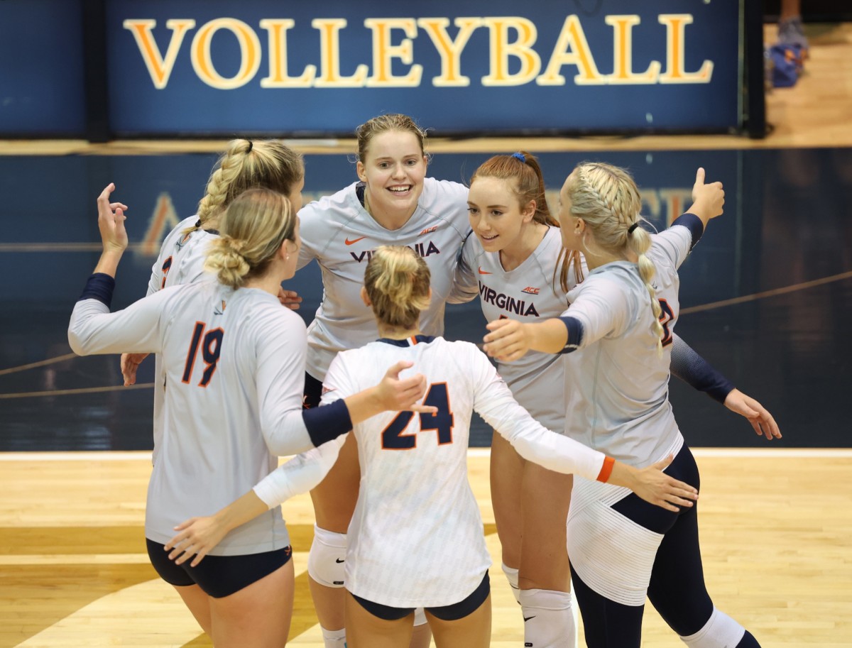 The Virginia volleyball team celebrates after scoring a point during their exhibition match.