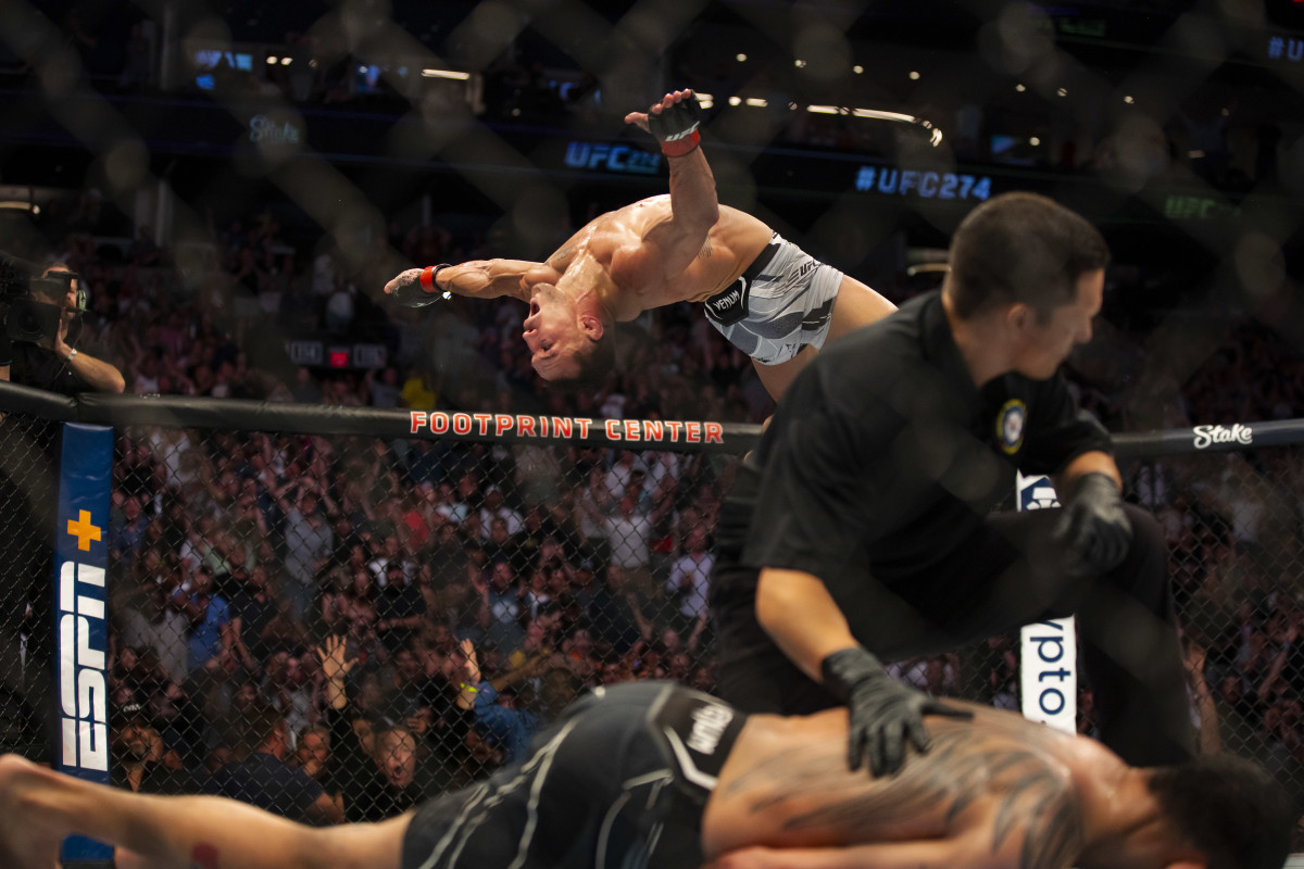 Michael Chandler does a backflip as he celebrates after knocking out Tony Ferguson during UFC 274 at Footprint Center.