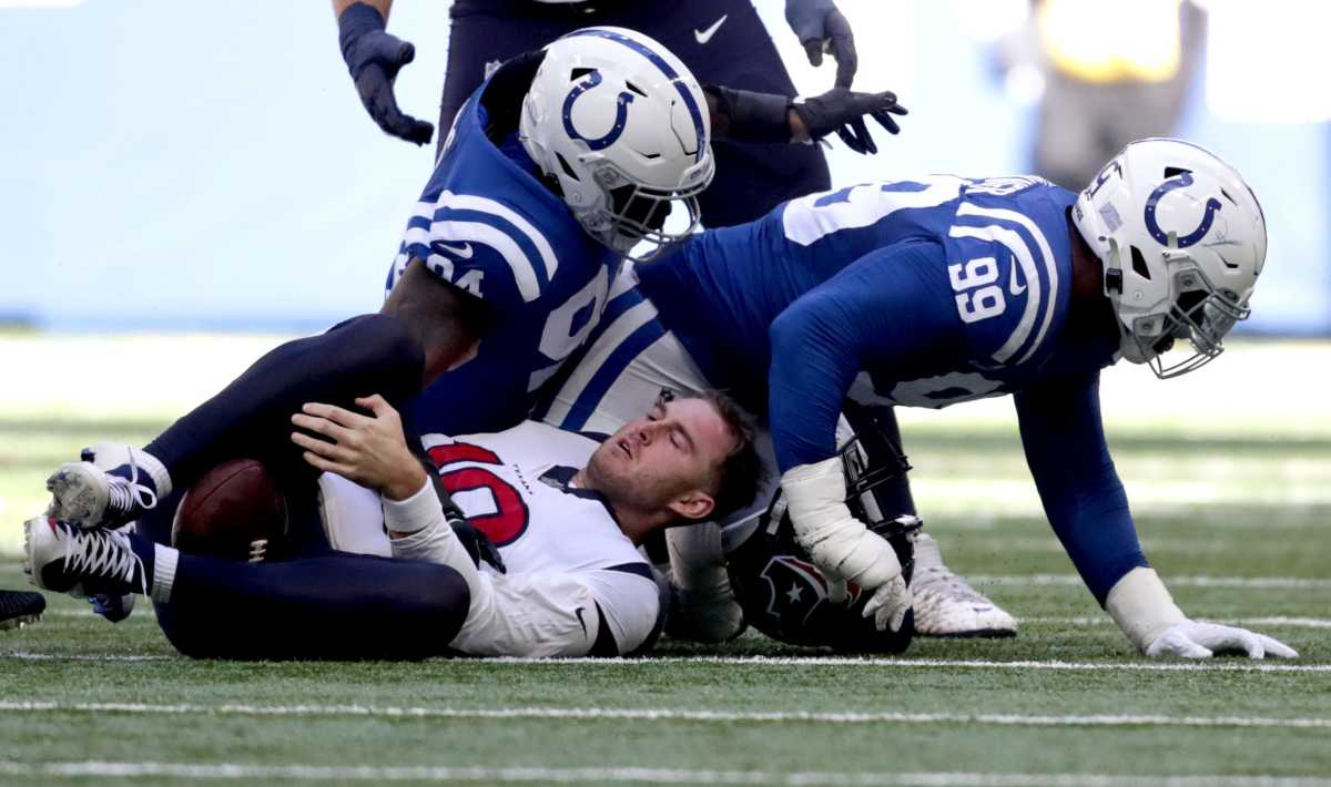 Indianapolis Colts defensive tackle DeForest Buckner (99) and Indianapolis Colts defensive end Tyquan Lewis (94) get up after sacking Houston Texans quarterback Davis Mills (10) on Sunday, Oct. 17, 2021, during a game against the Houston Texans at Lucas Oil Stadium in Indianapolis.