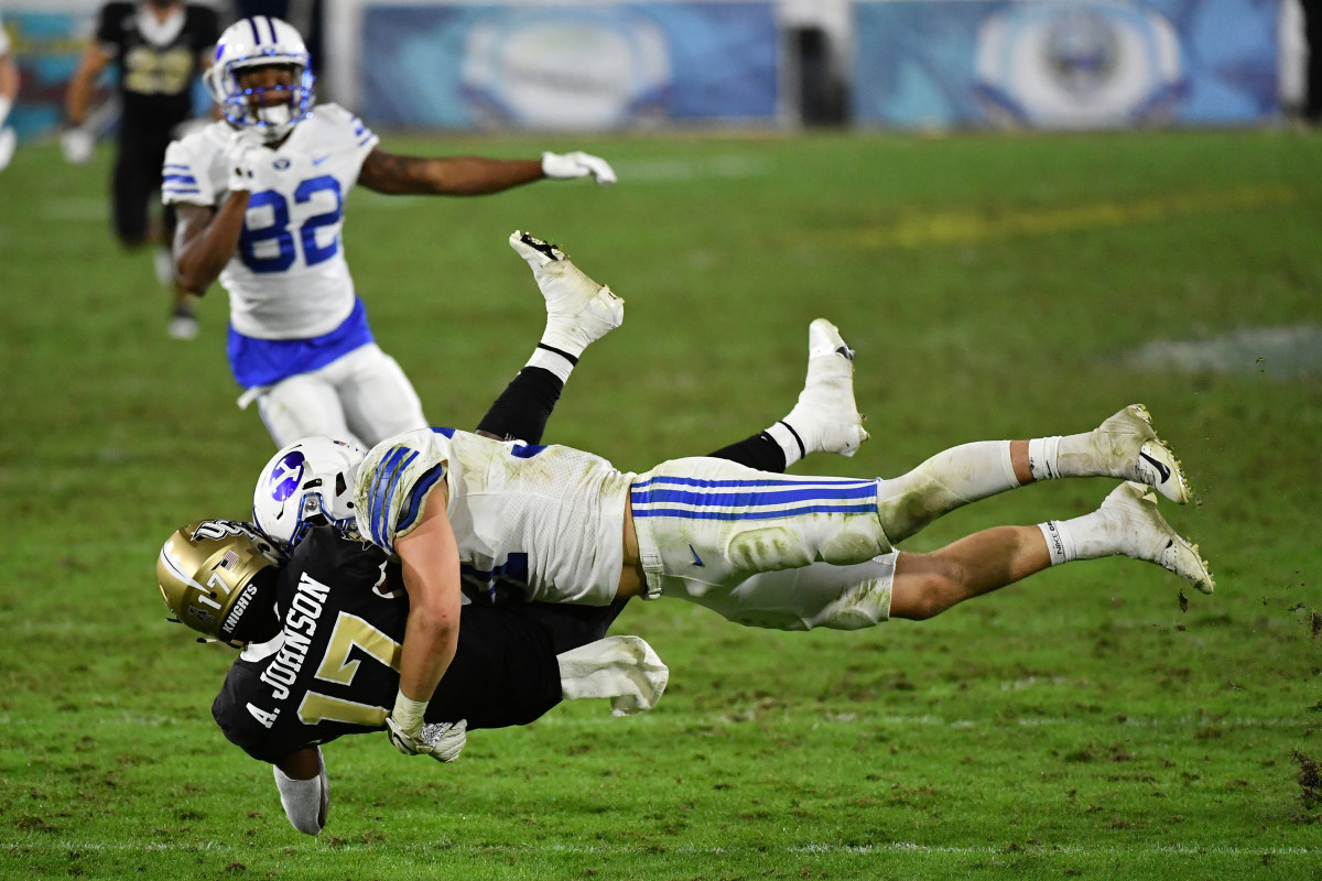 Dec 22, 2020; Boca Raton, Florida, USA; Brigham Young Cougars linebacker Max Tooley (31) tackles UCF Knights wide receiver Amari Johnson (17) on the punt return during the second half at FAU Stadium. Mandatory Credit: Jasen Vinlove-USA TODAY Sports