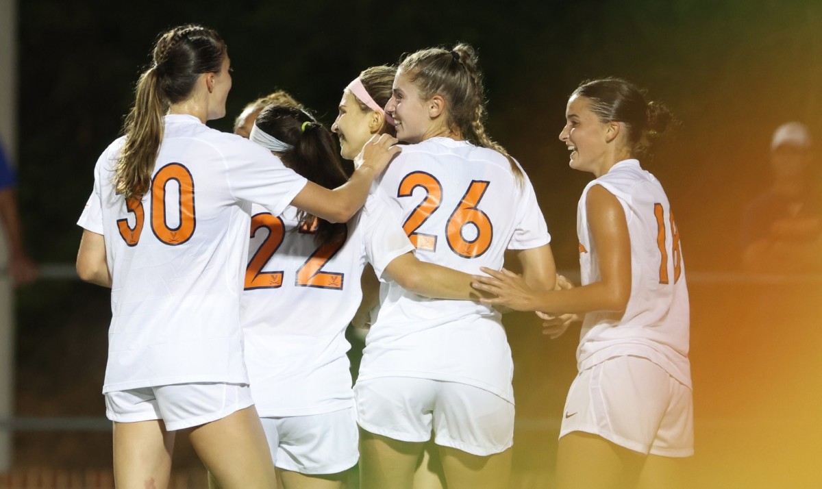 Maya Carter (26) and the UVA women's soccer team celebrate after scoring a goal.