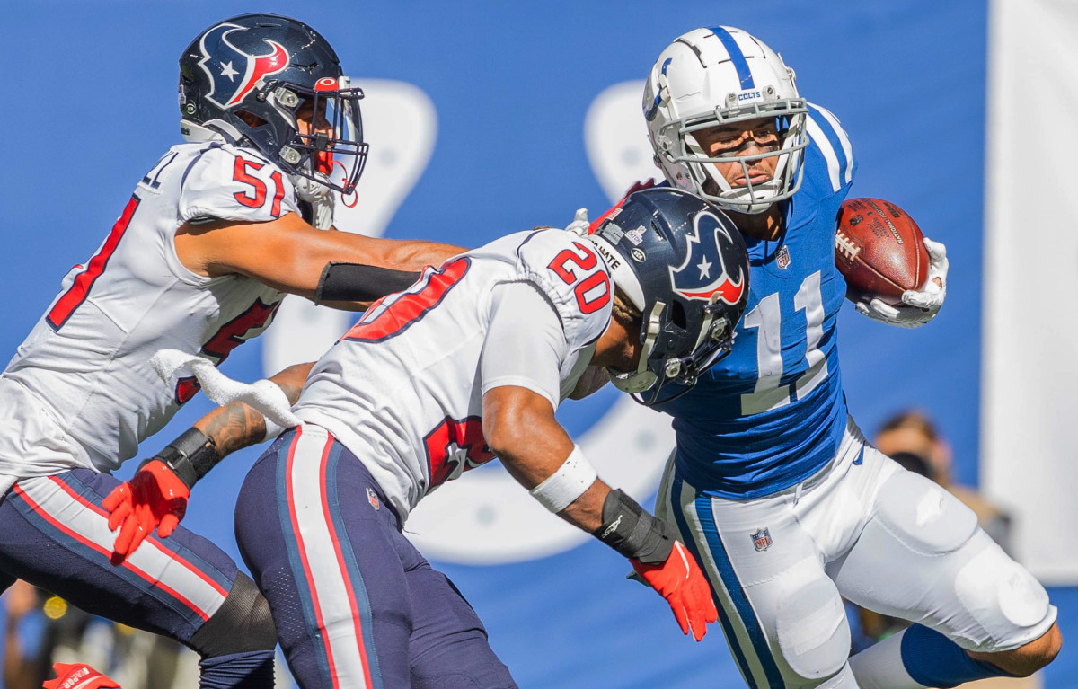 Oct 17, 2021; Indianapolis, Indiana, USA; Indianapolis Colts wide receiver Michael Pittman (11) catches the ball while Houston Texans outside linebacker Kamu Grugier-Hill (51) and Houston Texans safety Justin Reid (20) defend in the first half at Lucas Oil Stadium.