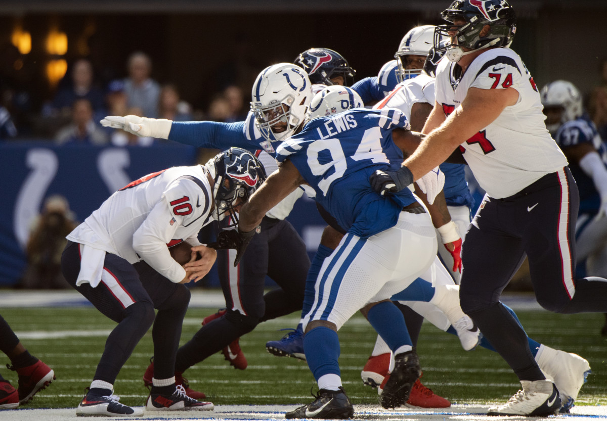 Oct 17, 2021; Indianapolis, Indiana, USA; Houston Texans quarterback Davis Mills (10) is sacked by Indianapolis Colts defensive tackle DeForest Buckner (99) and Indianapolis Colts defensive end Tyquan Lewis (94) during the first quarter at Lucas Oil Stadium.