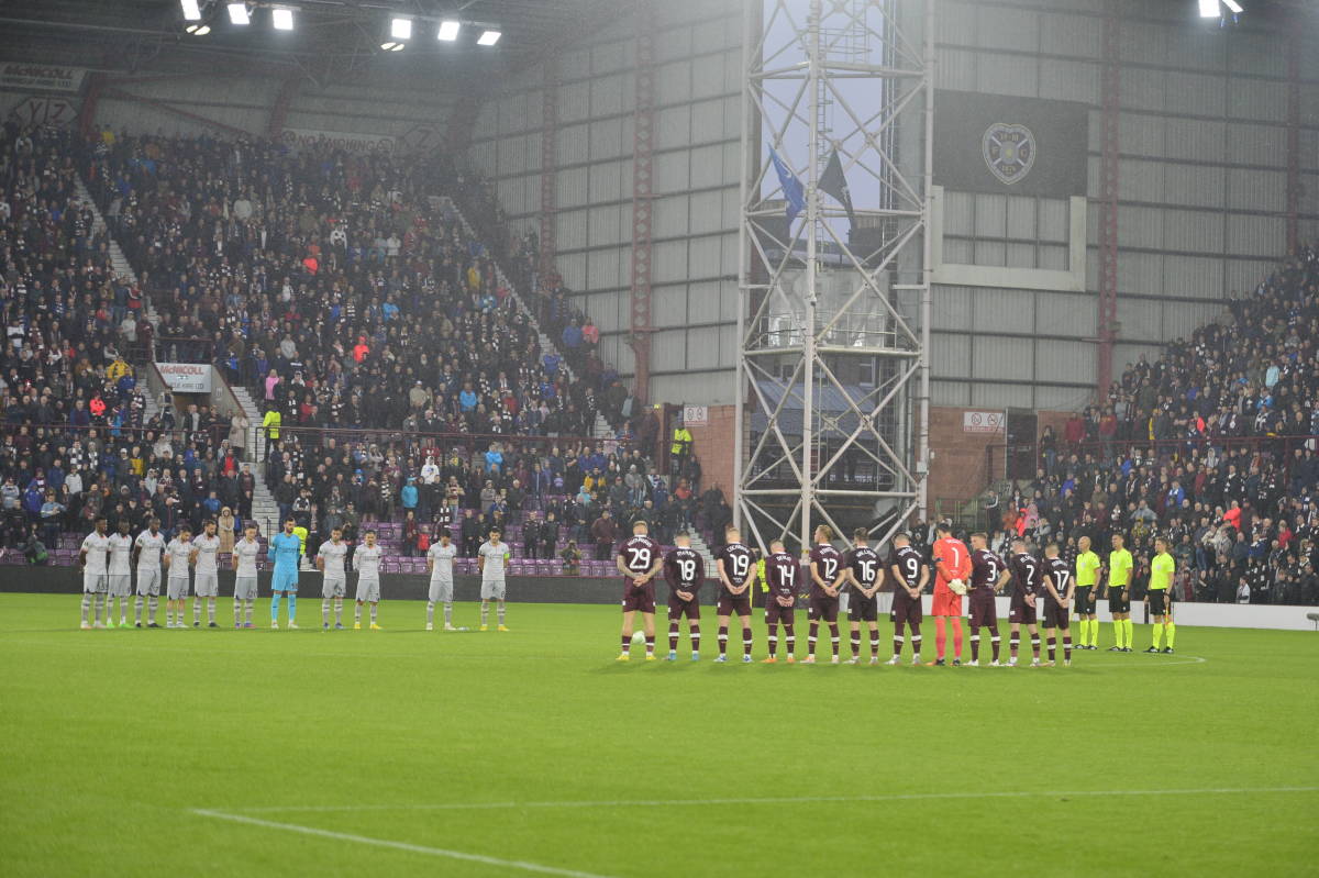 Players from Heart of Midlothian and Istanbul Basaksehir pictured standing around the center circle during a moment of silence following the death of Queen Elizabeth II