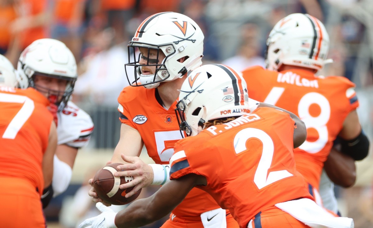 Virginia quarterback Brennan Armstrong hands the ball off to running back Perris Jones during UVA's 34-17 victory over Richmond on Saturday.