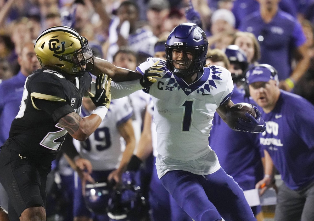 TCU Horned Frogs wide receiver Quentin Johnston (1) stiff arms Colorado Buffaloes safety Isaiah Lewis (23) in the second quarter at Folsom Field.