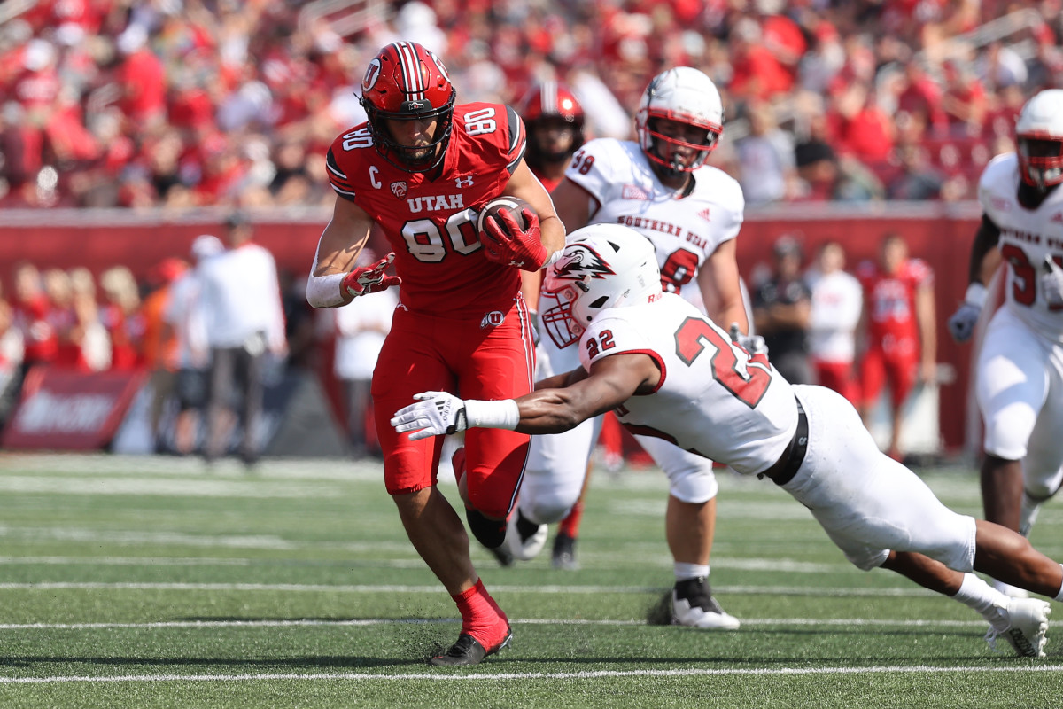 Utah Utes tight end Brant Kuithe (80) is tackled after a catch by Southern Utah Thunderbirds linebacker Aubrey Nellems (22) in the first quarter at Rice-Eccles Stadium.