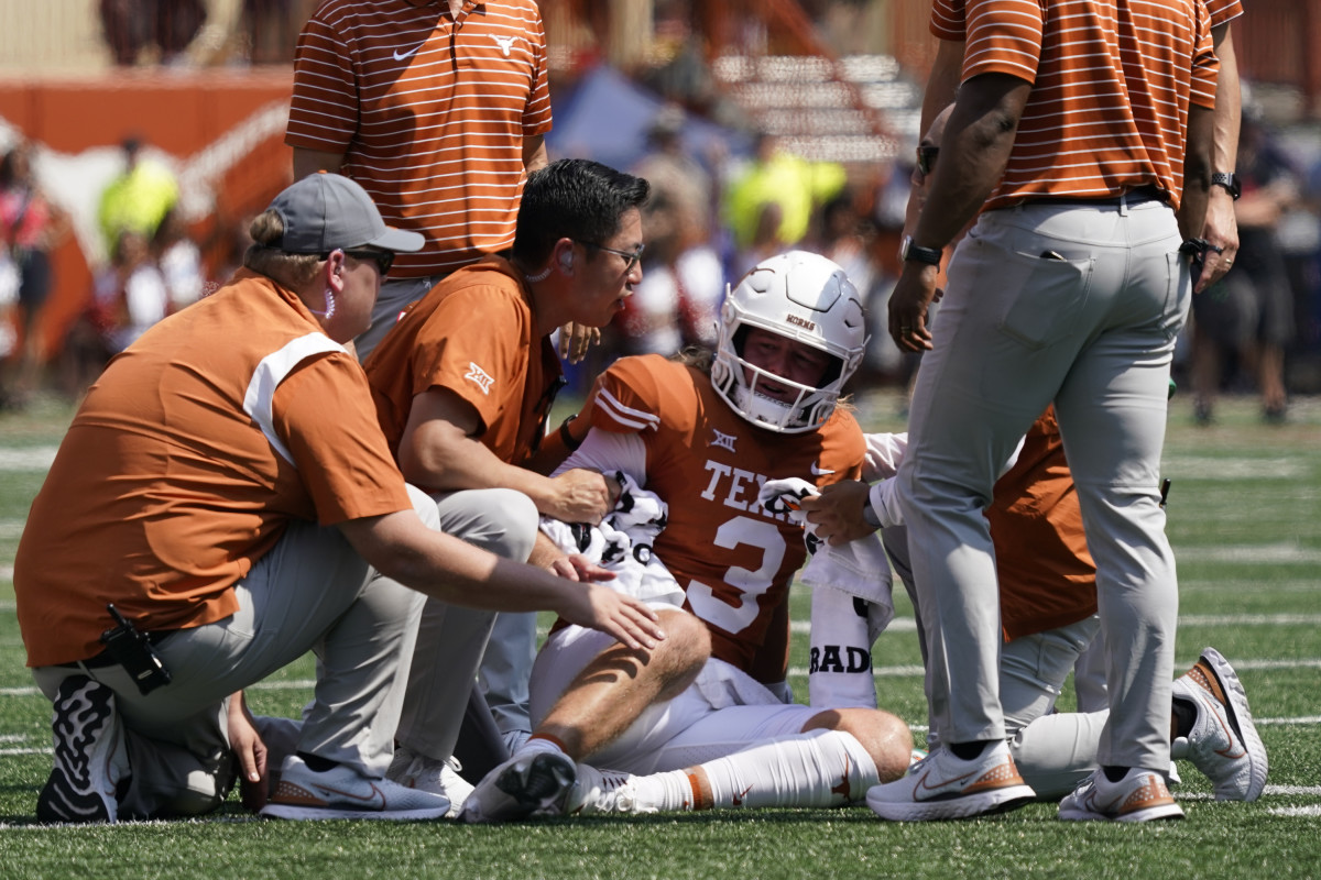 Texas Longhorns quarterback Quinn Ewers (3) is attended to after getting hit while throwing a pass against the Alabama Crimson Tide during the first half at at Darrell K Royal-Texas Memorial Stadium.