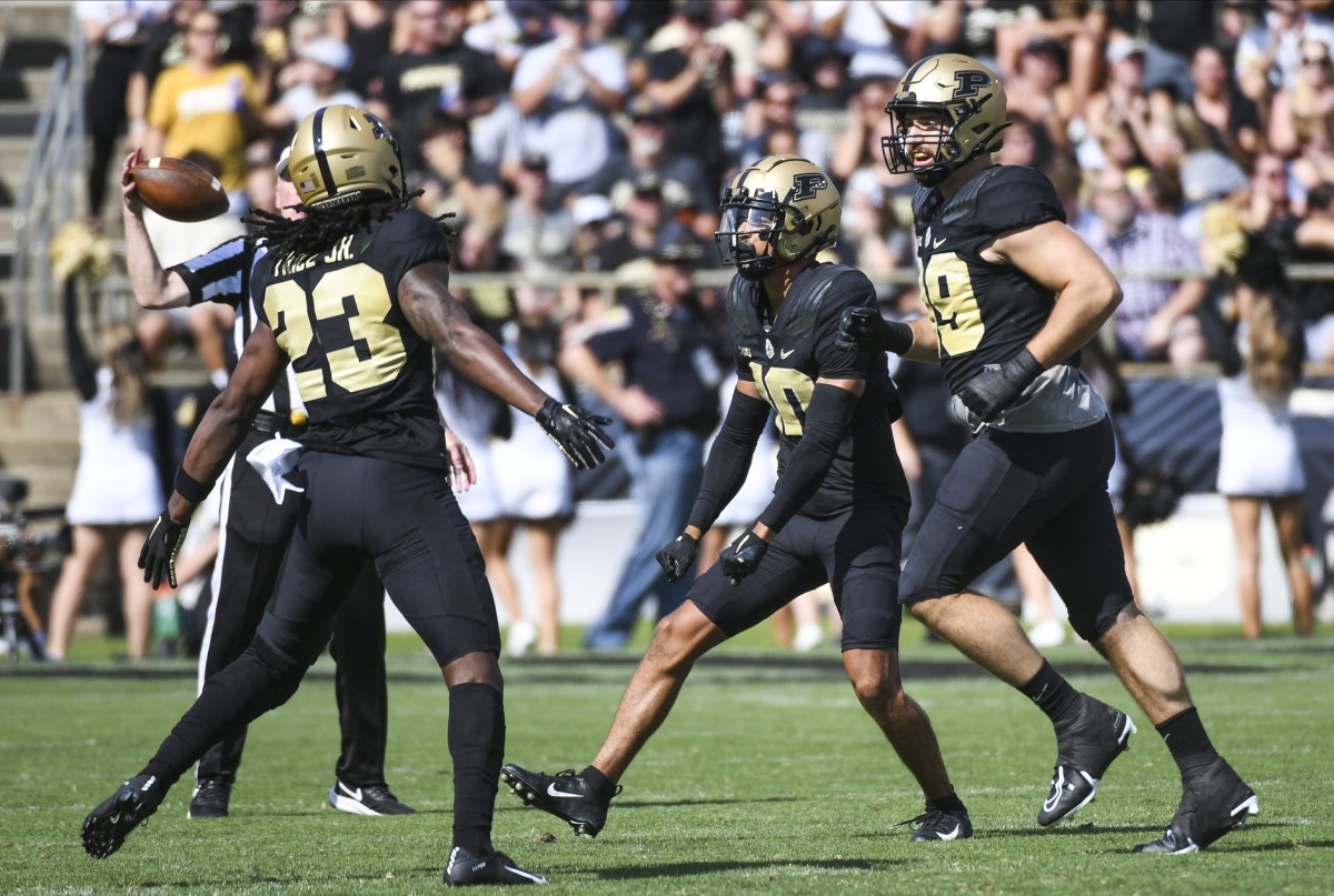 Sep 10, 2022; West Lafayette, Indiana, USA; Purdue Boilermakers cornerback Cory Trice (23), Purdue Boilermakers safety Cam Allen (10) and Purdue Boilermakers defensive end Jack Sullivan (99) celebrate after forcing a turnover during the first quarter against the Indiana State Sycamores at Ross-Ade Stadium.