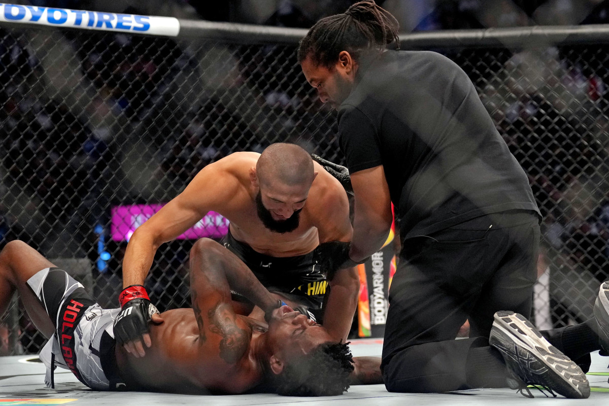 Khamzat Chimaev (red gloves) fights Kevin Holland (blue gloves) during UFC 279 at T-Mobile Arena