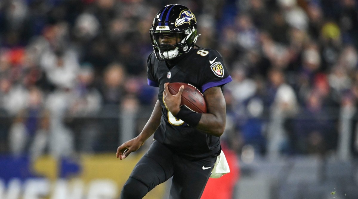 Ravens quarterback Lamar Jackson (8) rushes during the second half of a game against the Cleveland Browns