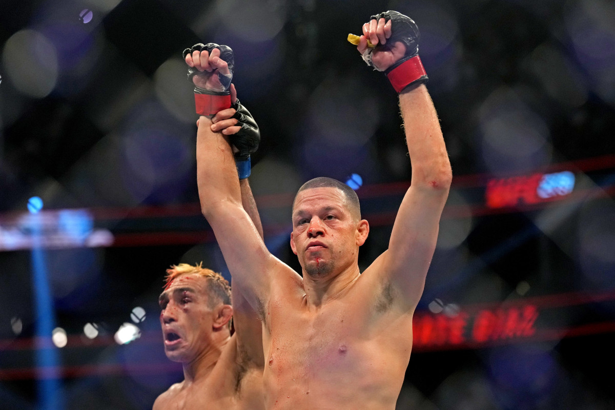 Nate Diaz fights Tony Ferguson (blue gloves) during UFC 279 at T-Mobile Arena.