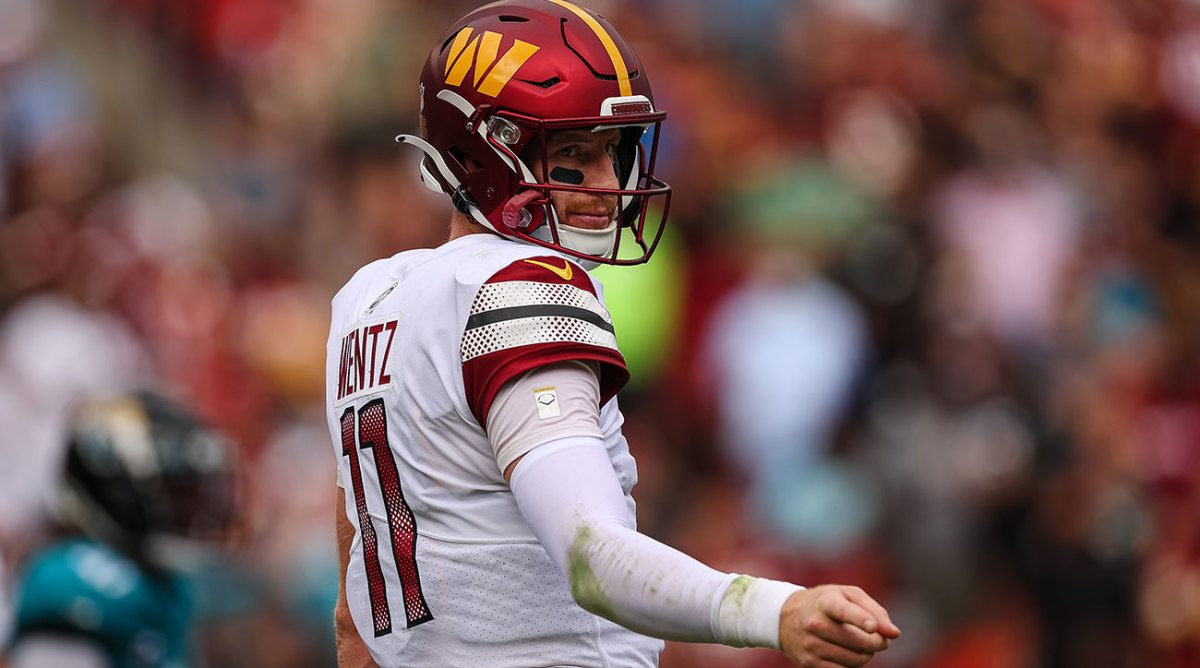 Carson Wentz points forward in a win during his Commanders debut.