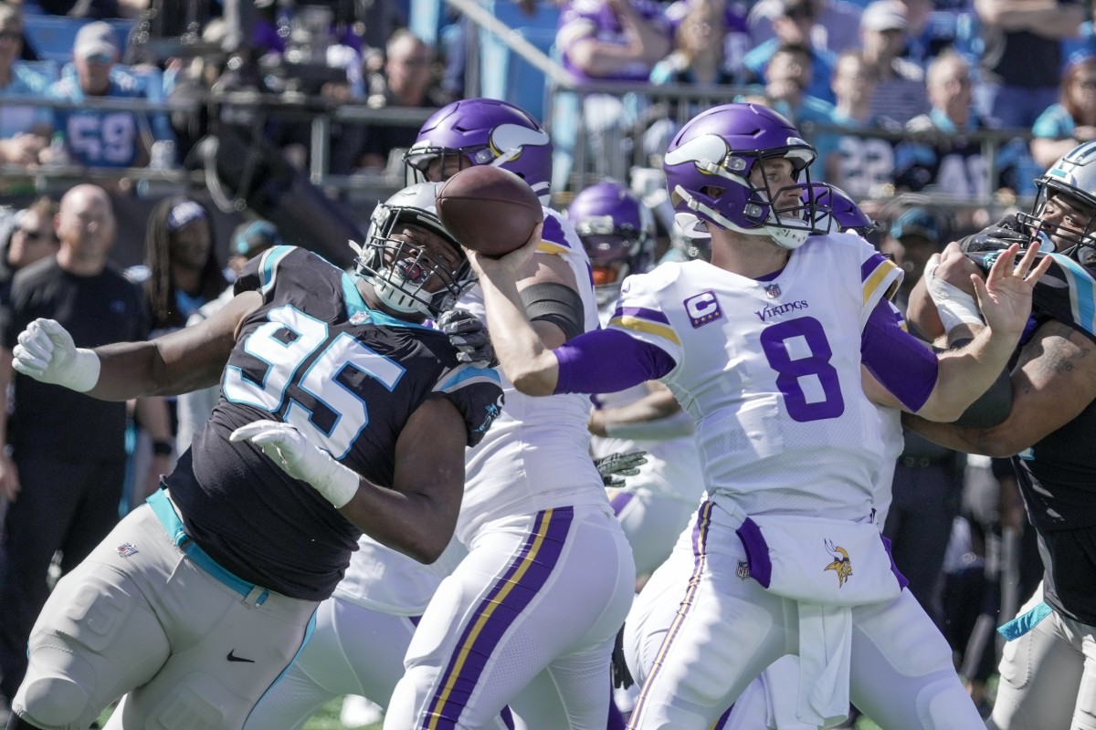 Oct 17, 2021; Charlotte, North Carolina, USA; Minnesota Vikings quarterback Kirk Cousins (8) cocks his arm for a pass under pressure from Carolina Panthers defensive tackle Derrick Brown (95) during the first quarter at Bank of America Stadium. Mandatory Credit: Jim Dedmon-USA TODAY Sports